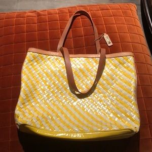 This is a yellow and white ColeHaan handbag.